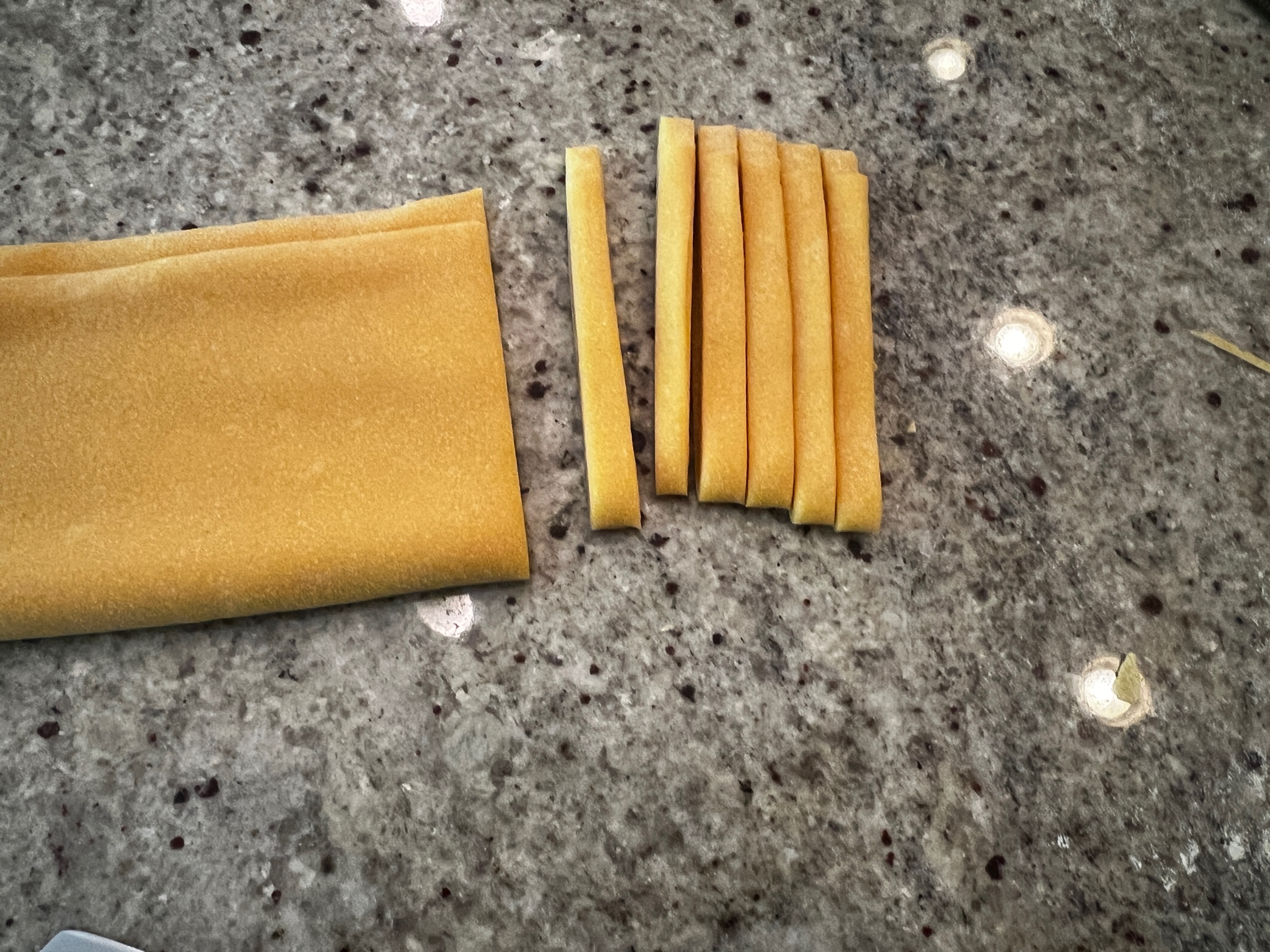 Several pieces of pasta on a counter

AI-generated content may be incorrect.